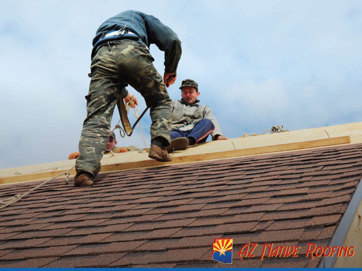 Roofers working on a roof, illustrating roofing contractor costs